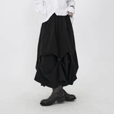 ブラックのアシンメトリースカート 着用 正面 金属ボタン