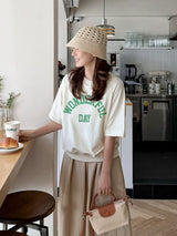 クリームのアーチロゴ半袖Tシャツ 着用 カフェ