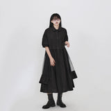 ブラックのシャツワンピース 着用 手を添えた姿